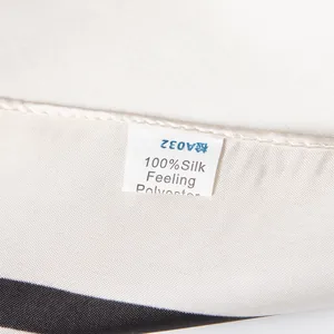 Detail of 100% silk feeling polyester scarf label showing fabric texture and care tag