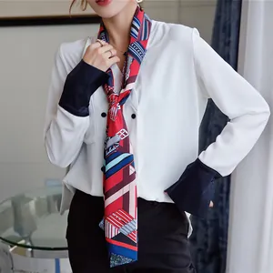 Detail view of double-layer geometric silk twilly with horse-bit print and belt pattern