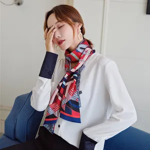 Detail of multi-color geometric striped silk scarf tied elegantly around model's neck