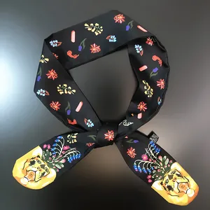 Detail of floral twilly scarf with tiger head print on smooth black silk fabric