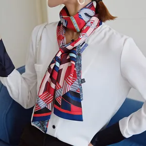 Detail of a geometric printed silk scarf tied around a white shirt collar