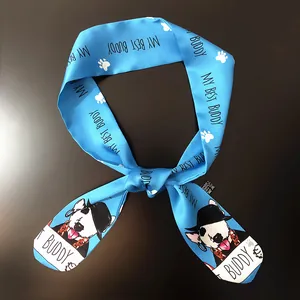 Close-up of blue silk twilly featuring dog paw prints and cartoon bulldog illustrations