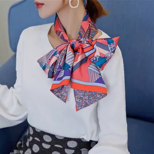 Detail of silk scarf tied in a bow featuring vibrant geometric and floral patterns