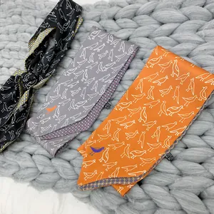 Three elegant double-layered silk twilly scarves with bird patterns on a knit background