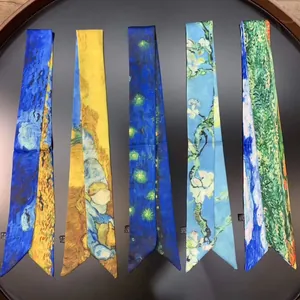 Detail of five narrow silk ribbons featuring Van Gogh oil painting prints on a black tray