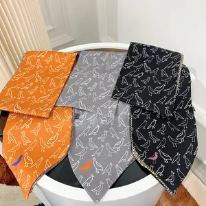 Elegant satin scarves in orange, gray, and black featuring minimalist bird print patterns