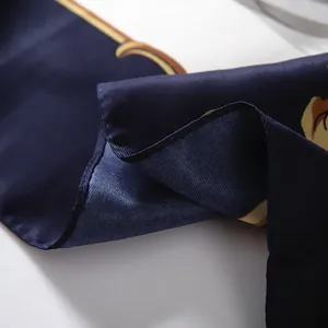 Close-up of luxury silk scarf showing fine stitching and vintage nautical pattern detail