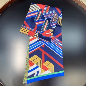 Macro detail of silk scarf featuring complex geometric stripes and belt buckle patterns