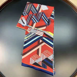 Detail of silk scarf showing belt geometric patterns and equestrian motifs on a tray