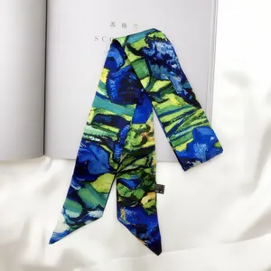 Detail of a silky twilly scarf with blue iris floral pattern on white satin background