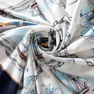 Macro shot of satin square scarf with nautical sailing prints and navy blue borders