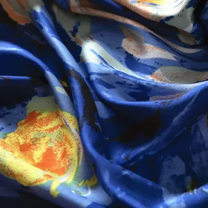 Detailed close-up of blue Van Gogh starry sky art print on silky satin scarf fabric