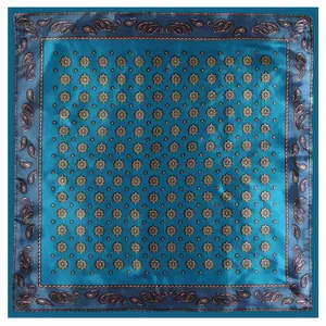 Detailed pattern of a square peacock blue paisley silk scarf with vintage geometry