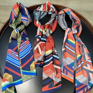 Detailed close-up of colorful silk scarves with geometric patterns on a black tray