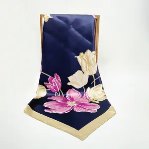 Detail of silk-like satin square scarf with navy blue base and tulip floral pattern