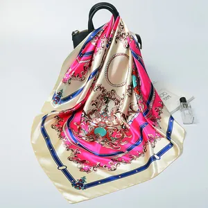 Royal court style silk square scarf with baroque patterns draped over a black handbag