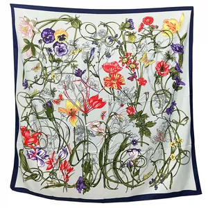Close-up detail of silk square scarf featuring vibrant floral botanical prints and butterflies
