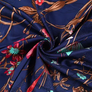 Macro shot of navy blue floral silk shawl showing detailed rose pattern and silky texture