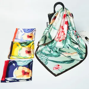 Close-up of squirrel sunflower print silk scarves with contrast piping on a handbag