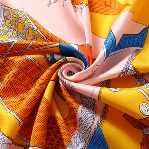 Macro shot of elegant satin silk scarf featuring orange and pink rope patterns