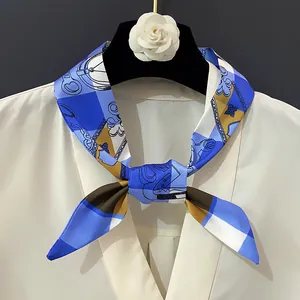 Elegant geometric floral print silk scarf styled with a white shirt and camellia decor