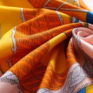 Detailed macro view of the silky satin scarf texture with vibrant ethnic patterns