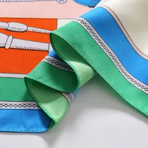 Macro shot of silk scarf showing equestrian patterns with bits and reins in vibrant colors