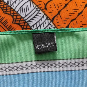 Detail of 100% silk label on a colorful patterned scarf with high-quality stitching