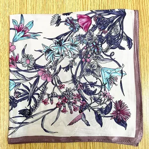 Detail of floral silk square scarf featuring hummingbirds and butterfly prints