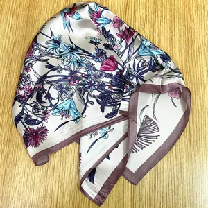 Detail of floral silk scarf featuring botanical prints and elegant satin sheen texture