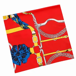 Red silk square scarf featuring elegant gold belt and chain prints on white background