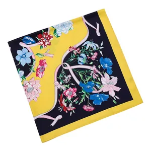 Detailed pattern of floral silk scarf featuring yellow and blue color block and ribbons