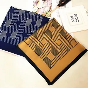 Silk-textured square scarf with geometric maze pattern in navy blue and golden yellow