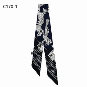 Detailed view of dark blue zebra print twilly scarf with geometric patterns and labels