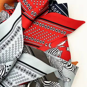 Macro shot of assorted silk scarves featuring animal prints and paisley patterns