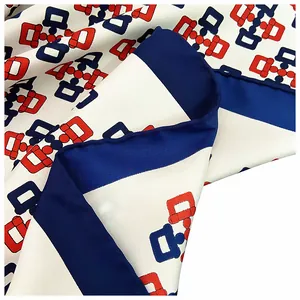 Macro detail of hand-rolled edges and luxury chain patterns on ivory silk scarf