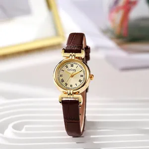 Macro detail of retro gold quartz watch with champagne Roman dial and brown leather strap