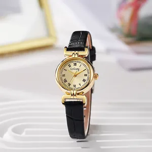 Detail of elegant gold case and black crocodile leather strap on vintage women's watch