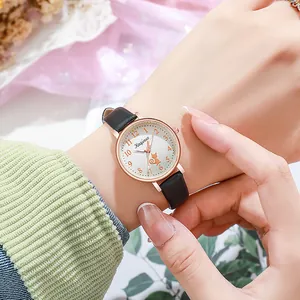 Detail of rose gold cat watch for women with black leather strap and white dial