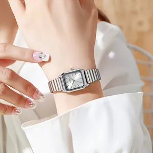 Close-up of vintage square silver ladies watch with elastic metal strap and sunray dial