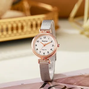 Detail of rose gold case and silver mesh band on an elegant minimalist women watch