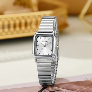 Detail of vintage square silver ladies watch with elastic metal strap and sunburst dial