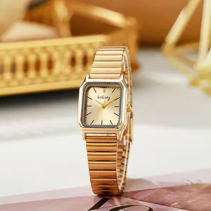 Detail of vintage square gold watch with minimalist dial and elastic bracelet strap