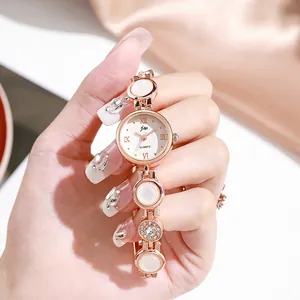 Rose gold steel bracelet watch for women featuring opal-style stones and Roman numerals