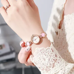 Women's rose gold quartz watch with pink gemstone bracelet and Roman numeral dial