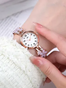 Detail shot of rose gold floral watch with pink enamel flowers and sparkling crystals