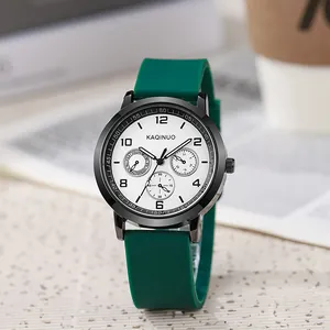 Detail of dark green silicone strap and black multi-function chronograph watch face