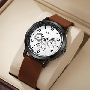 Detail view of the KAQINUO quartz watch with white dial, sub-dials, and brown strap