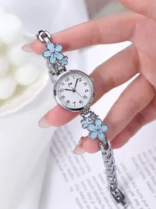 Detail of silver ladies watch with floral bracelet and blue rhinestone accents