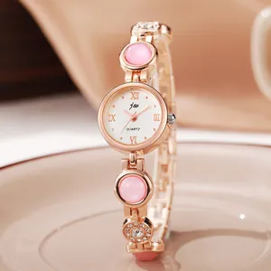 Elegant rose gold women's quartz watch with pink cat-eye stone bracelet and Roman numerals